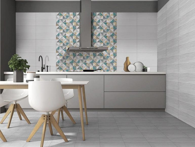 Stylish open kitchen design with grey cabinets, patterned backsplash tiles, and a modern dining area.